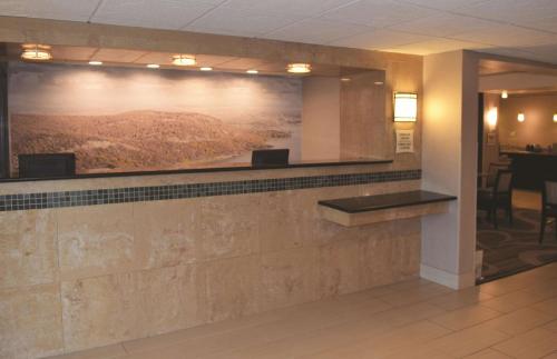 a lobby with a large painting on the wall at La Quinta Inn by Wyndham Binghamton - Johnson City in Johnson City