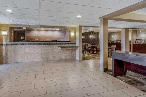 a large lobby with a bar and a restaurant at La Quinta Inn by Wyndham Binghamton - Johnson City in Johnson City