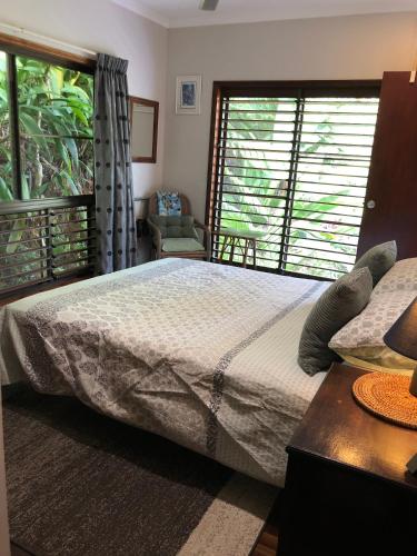 a bedroom with a large bed and a window at Mossman Gorge Bed and Breakfast in Mossman