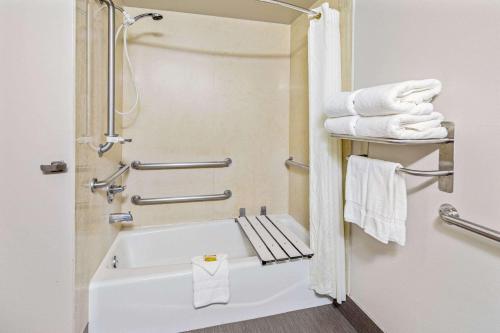 a bathroom with a white tub and towels at La Quinta by Wyndham Temecula in Temecula