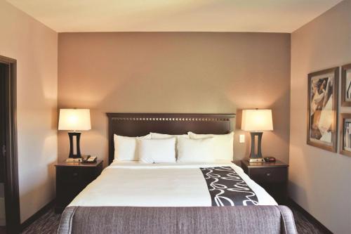 a hotel room with a large bed with two lamps at La Quinta by Wyndham Abilene Mall in Abilene