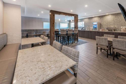 a kitchen with wooden floors and wooden tables at La Quinta by Wyndham Bozeman in Bozeman