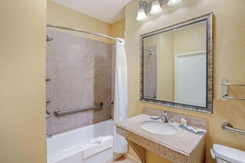 a bathroom with a sink and a shower with a mirror at La Quinta by Wyndham Vicksburg in Vicksburg