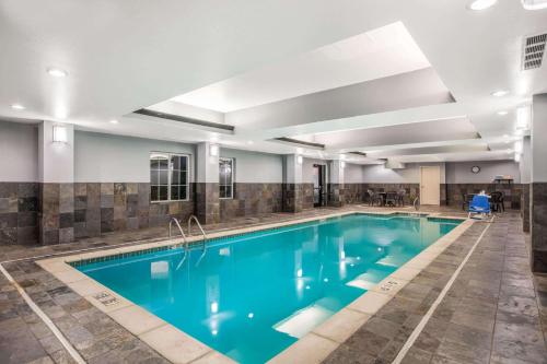 a swimming pool with blue water in a building at La Quinta by Wyndham Conway in Conway