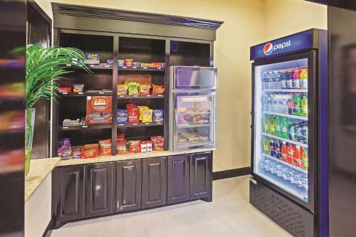 a grocery store with an open refrigerator next to a refrigerator freezer at La Quinta by Wyndham Marshall in Marshall