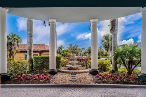 a pavilion with a fountain in a garden at La Quinta by Wyndham Naples Downtown in Naples