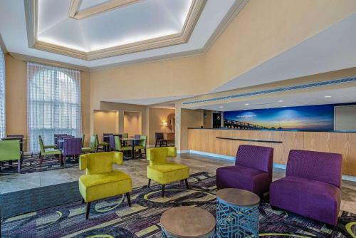 a lobby with colorful chairs and a waiting room at La Quinta by Wyndham Naples Downtown in Naples