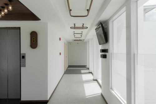 a corridor in a building with white walls at Hotel Amber Sukhumvit 85 in Bangkok