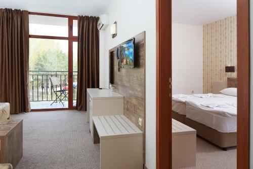 a hotel room with a bed and a balcony at Hotel Lira in Sunny Beach
