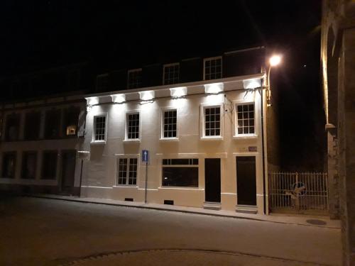 a white building with lights on it at night at Gîtes le second à Spa (gîte de 2 et de 5 personnes) in Spa