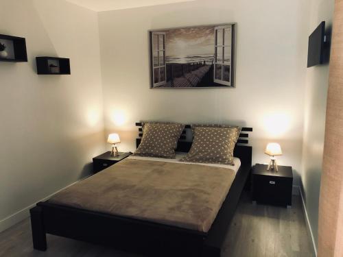 a bedroom with a bed with two night stands at Gîte avec jardin à 1,5 km des plages du débarquement in Tracy-sur-Mer