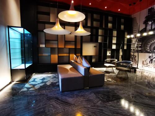a living room with a couch and two lights at Paco Hotel BeiJing Road Metro Guangzhou-Free Shuttle Bus For Canton Fair in Guangzhou