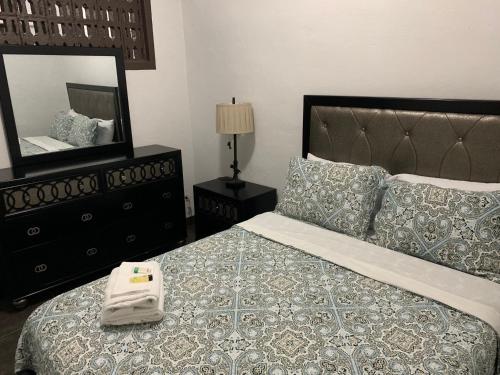 a bedroom with a large bed with a mirror at BEAUTIFUL 3 BEDROOM PRIVATE UNIT, FREE PARKING, FREE WIFI in Sinajana