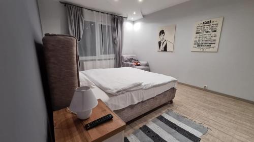 トゥルグ・ムレシュにあるMaris Apartmentの小さなベッドルーム(ベッド1台、テーブル付)