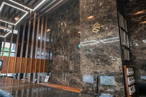 a stone wall in a building with a hotel lobby at Hotel RU136 in Seoul
