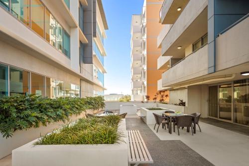 a courtyard in a building with tables and chairs at Quest Chermside in Brisbane