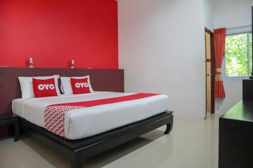 Un ou plusieurs lits dans un hébergement de l'établissement OYO 943 Siva Buri