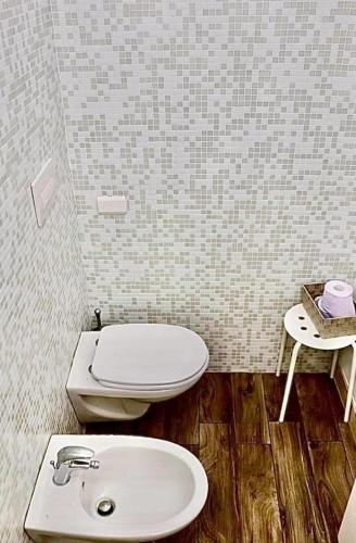 a bathroom with a toilet and a sink at Via ROMA 145 in Santeramo in Colle