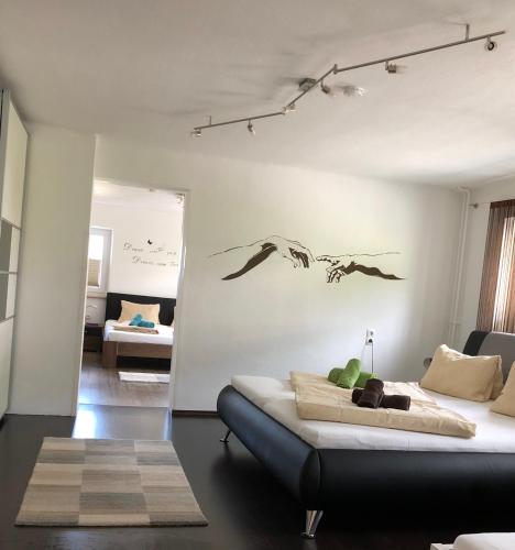 a bedroom with a bed with a painting on the wall at Landhaus Daum in Schwendau