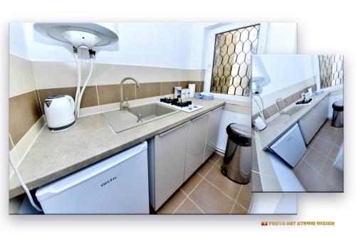 a kitchen with a sink and a counter top at Casa Fotografului in Constanţa