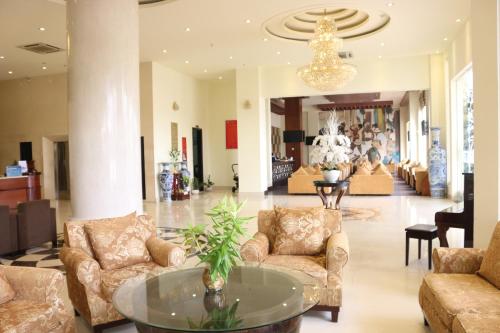 a lobby with couches and a table in a building at Viet Uc Hotel in Ben Tre