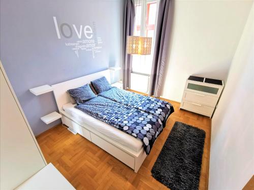 a small bedroom with a bed and a window at Gozsdu Apartment in Budapest