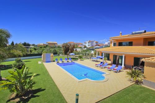 a swimming pool in the backyard of a house at Villa João Paulo in Albufeira
