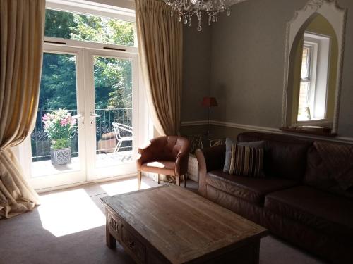 a living room with a couch and a coffee table at Chine Side in Shanklin