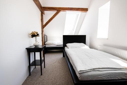 a bedroom with two beds and a window at Penzion Zlaté Slunce in Chocenice