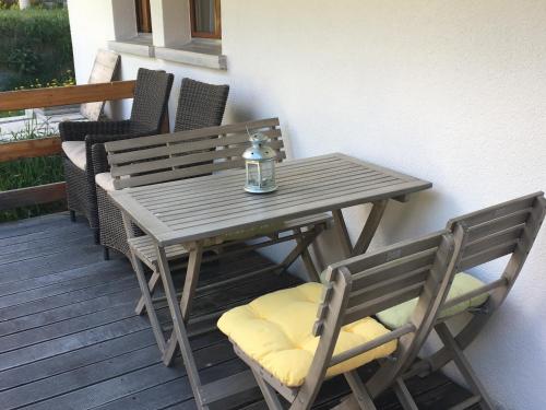 a wooden table and chairs sitting on a deck at Haus Leopold in Zermatt