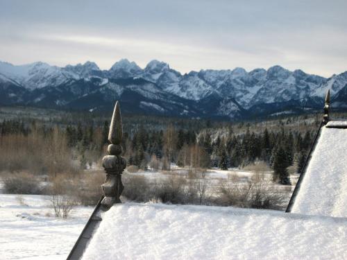 a view of a snow covered mountain range from a building at Pokoje ,,Goramiba''Jurgów in Jurgów
