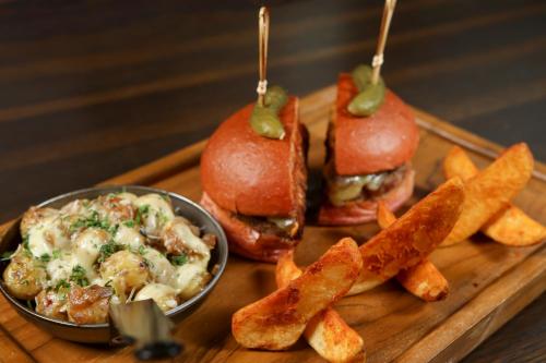 a tray of food with two sandwiches and french fries at InterContinental Dhaka by IHG in Dhaka