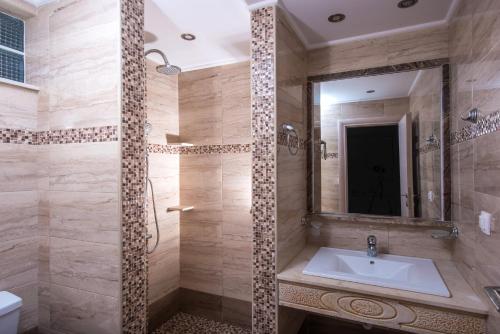 a bathroom with a sink and a mirror at I Candy Malia by Estia in Malia
