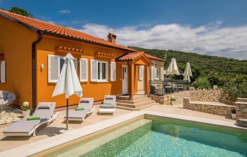 a villa with a swimming pool and a house at Hacienda Babina in Miholašćica
