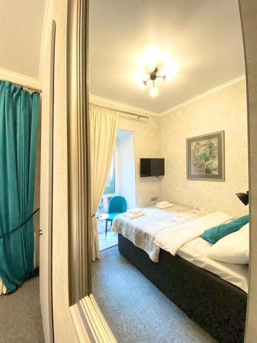 a hotel room with a bed and a mirror at Готель Art Gallery in Odesa