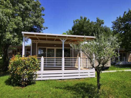a house with a white fence in a yard at The Garda Village in Sirmione