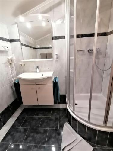 a bathroom with a sink and a shower at Der Bachwirt in Maria Alm am Steinernen Meer
