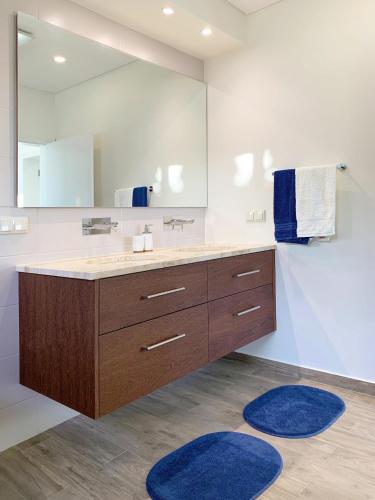 a bathroom with a sink and a large mirror at Holiday Apartment Sunset Ocean in Ribeira Brava