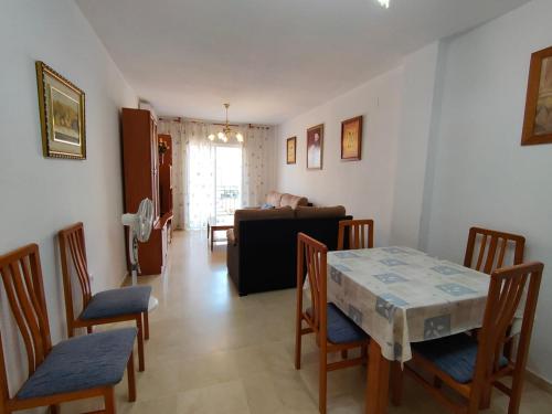 a living room with a table and chairs and a couch at Bonito Apartamento Vacacional in Motril