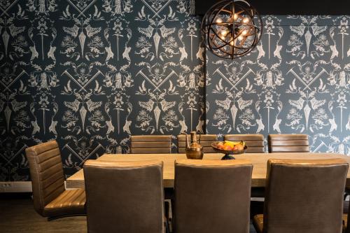 a dining room with a wooden table and chairs at Pointe Isabelle in Chamonix-Mont-Blanc