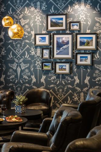 a room with chairs and pictures on the wall at Pointe Isabelle in Chamonix-Mont-Blanc