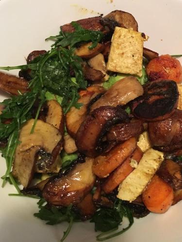 a plate of food with mushrooms and greens at Hotel-Restaurant Siesta Balea in Cumpăna