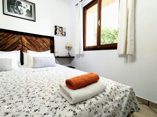 a bedroom with a bed with a towel on it at Ca na Maria in Manacor