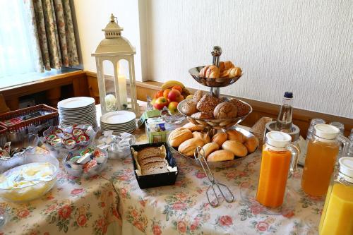 a table with bread and other foods on it at Hotel Kaiserpfalz in Paderborn