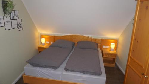 a bedroom with a bed with two pillows on it at Altstadtperle Wernigerode in Wernigerode