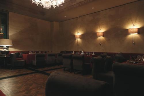 a dining room with tables and chairs and a chandelier at Hotel Riu Tikida Beach - Adults Only - All inclusive in Agadir