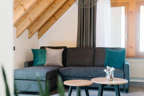 a living room with a couch and a table at Moderne 3 Zi.-FeWo BlackForestArt Nähe Freiburg in Simonswald