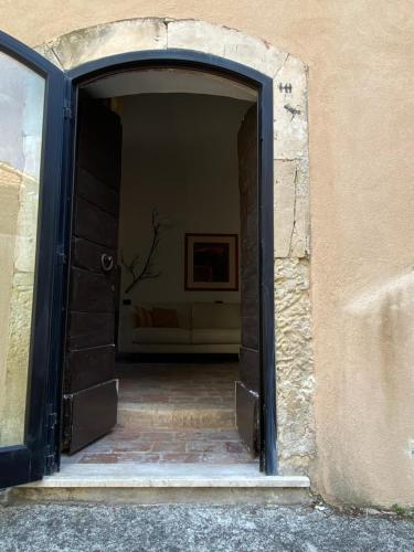 an open doorway into a building with a brick floor at Fisolare Suite romantica per due in Capestrano