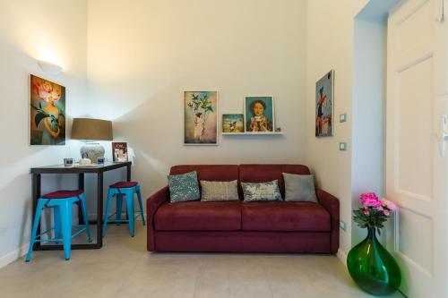 a living room with a red couch and a table at Casa Parravano in Caserta