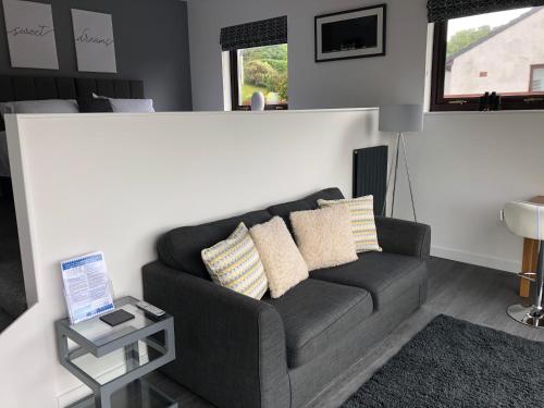 a living room with a couch and a table with a laptop at The apartment at Glendaruel in Portree